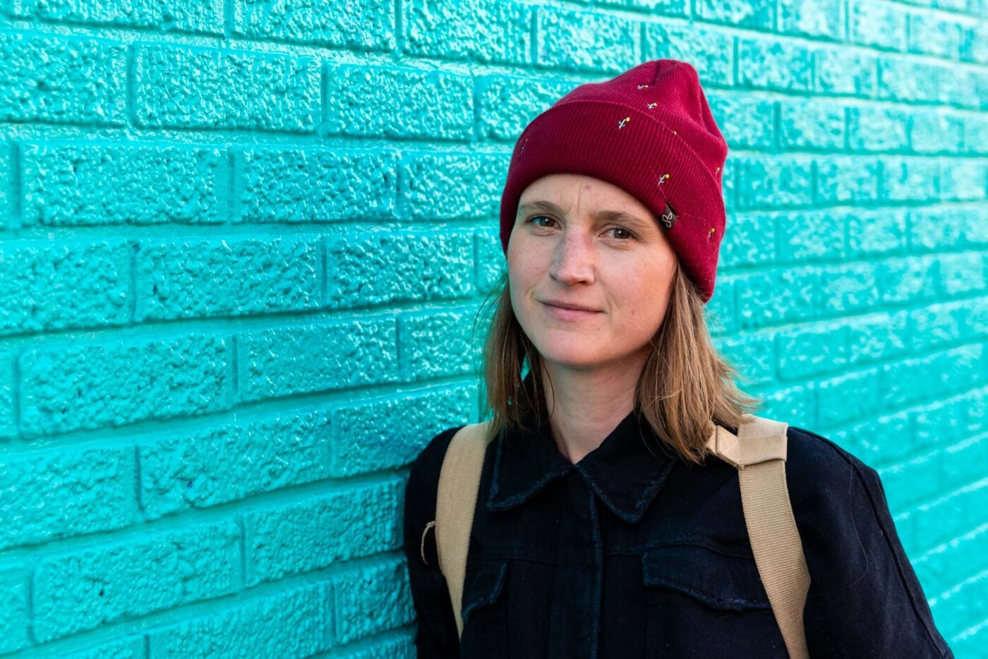 anika-teal-brick-wall-portrait