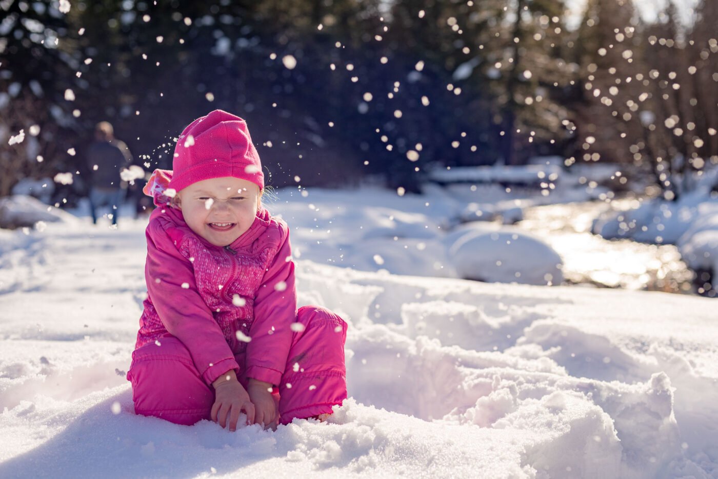 pink-girl-playing-snow-falling
