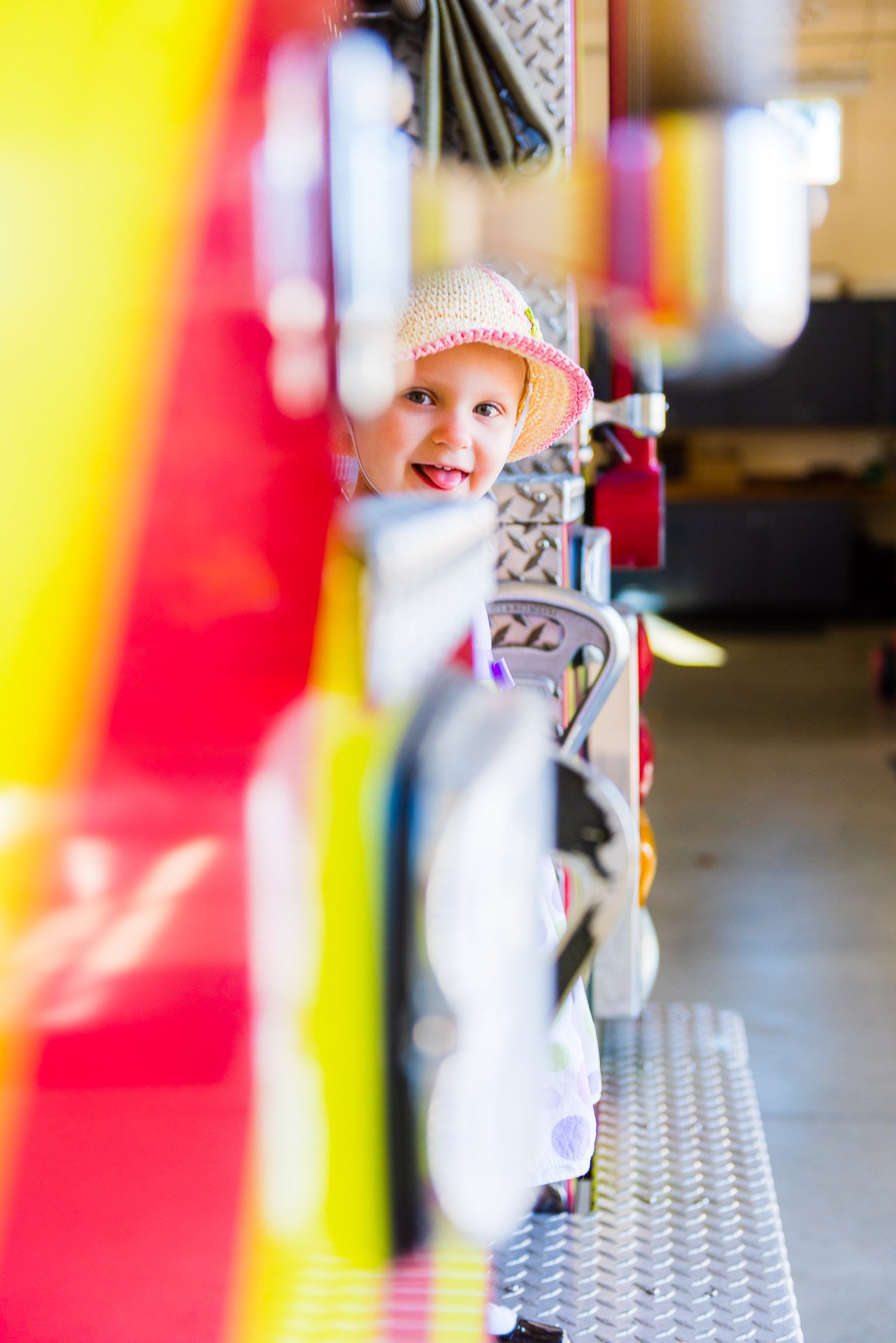 girl-peeking-around-fire-truck girl-peeking-around-fire-truck