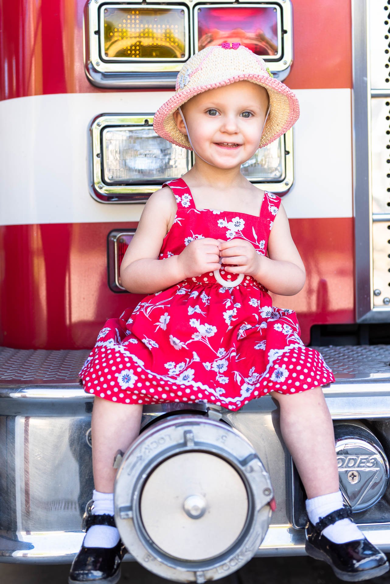 girl-sitting-on-a-fire-truck girl-sitting-on-a-fire-truck